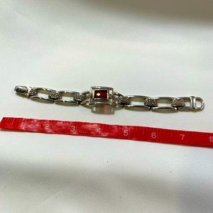 Silver rectangle, red center jewel